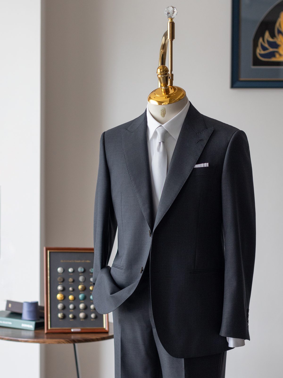 Bespoke charcoal worsted suit on a dress form