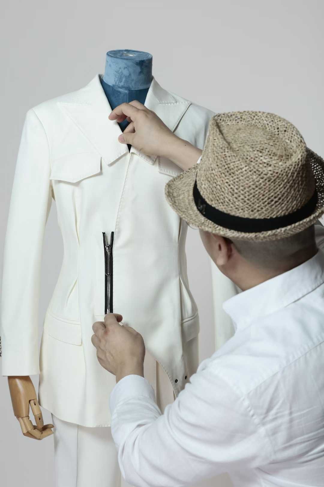 度·BESPOKE designer adjusting a jacket on a dress form