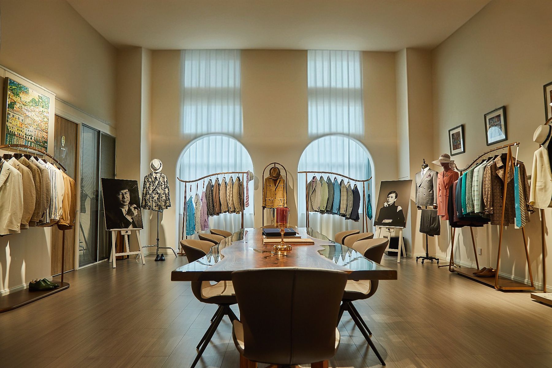 Wide view of the 度·BESPOKE showroom in Futian, Shenzhen: arched windows, garment rails and a live-edge table