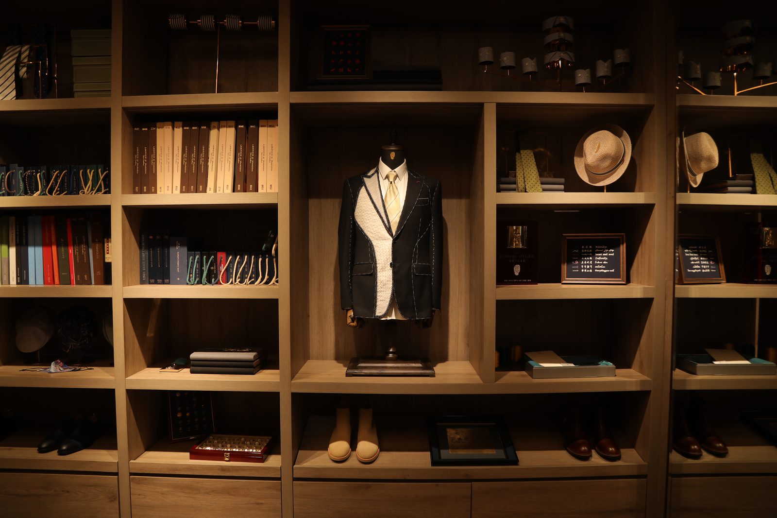 Half-made jacket displayed in a wooden grid shelf at 度·BESPOKE
